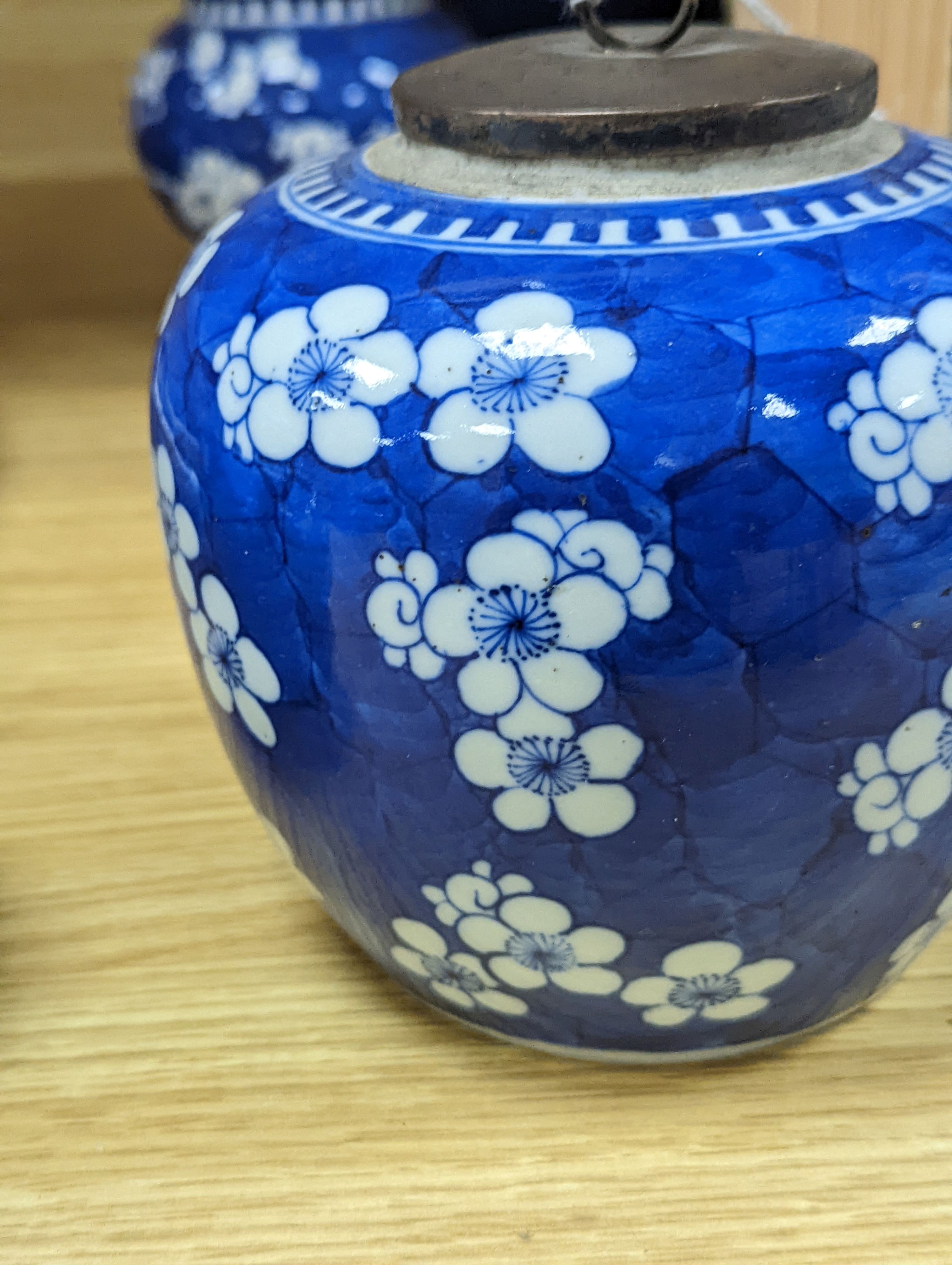 Three Chinese blue and white prunus decorated jars and covers, 19th/20th century, with four character marks 18cm